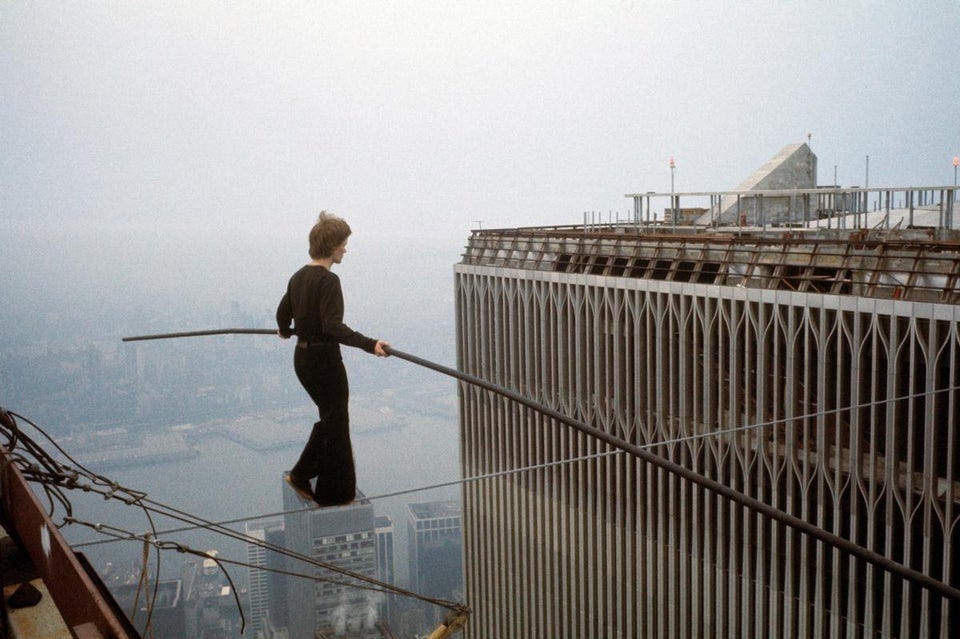 Philippe Petit wire-walking between the World Trade Centers in 1974, a slightly less impossible balancing act. source